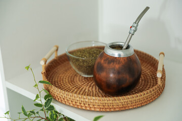 Traditional yerba mate tea on shelving unit indoors