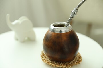 Traditional yerba mate tea on white table indoors, closeup