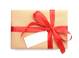 Gift wrapped in kraft paper with bow and card isolated on white, top view