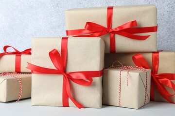 Many gift boxes wrapped in kraft paper on light table