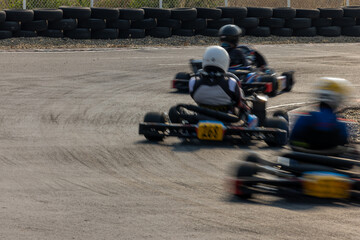 Motion blur kart driver drive go kart on kart race track circuit, Go kart racer driver on curve race track, Extreme sport .