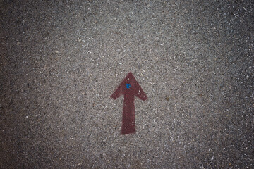 A drawn arrow on the asphalt