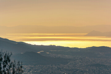 Athens cityscape and sea at golden sunset