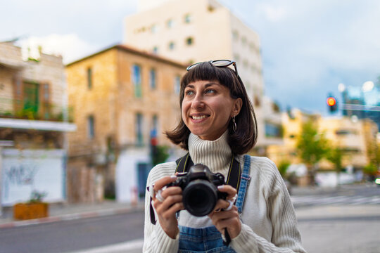 young girl with camera. photographer with camera. stylish girl with camera. takes photo.