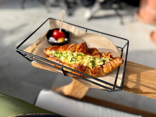 Croissant sandwich with egg at cafe shop in tray