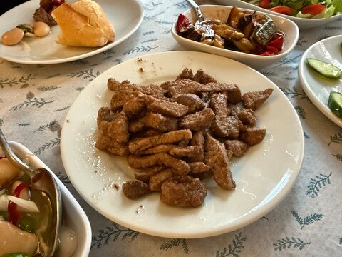 Traditional Turkish food ciger with onion, tomatoes and green pepper. Ciger made with beef liver. Beef liver marinated with milk and cooked in oil. Traditional street food in Turkey.