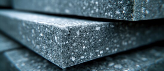 Close-up of gray insulation boards stacked; warehouse background; construction material