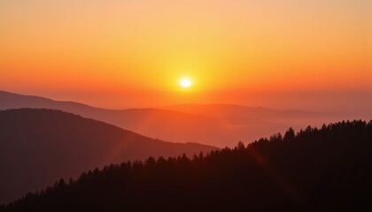 Vibrant orange sunrise over foggy forest hill with clear sky above, space for text, inspirational nature banner
