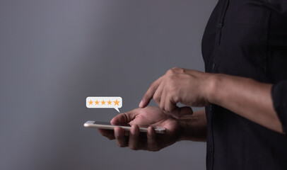 Customer Review, Young Man hand holding Smart Phone with five star to review and give 5 stars with...