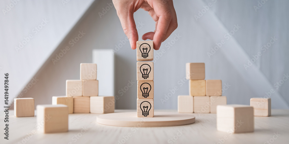 Poster wooden cubes with lightbulb icons stacked on a small platform, symbolizing idea generation and innov
