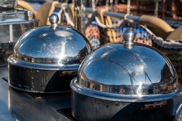 Two food warming domes with covers are displayed, showcasing the importance of food presentation....