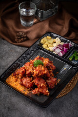 A plate of food with a glass of water on the table