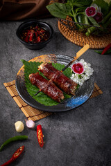 A plate of meat with a flower on top