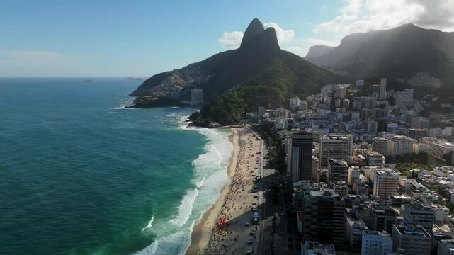 High-altitude aerial pull-back revealing Praia do Leblon beach and the coastline of Rio de Janeiro