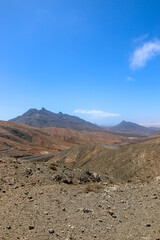Arid Volcanic Landscape of Fuerteventura Under Blue Sky