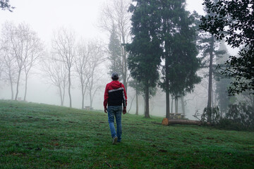 man trekking in the mountain with fog in winter season