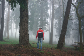 man trekking in the mountain with fog in winter season