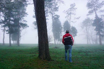 man trekking in the mountain with fog in winter season