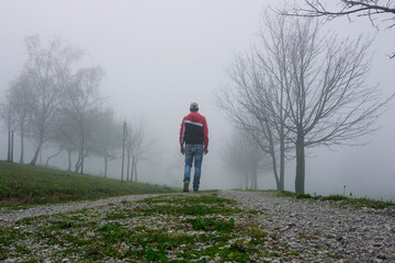 man trekking in the mountain with fog in winter season