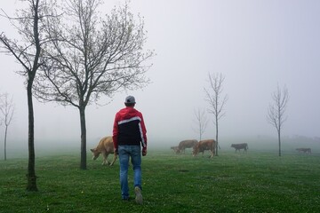 man trekking in the mountain with fog in winter season