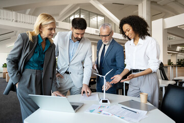 Business people discussing about renewable energy in modern office