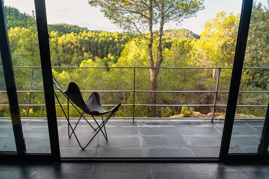 Terrace with chair to enjoy the amazing views of the forest at sunrise.