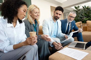 Business people working together on a project in office lobby