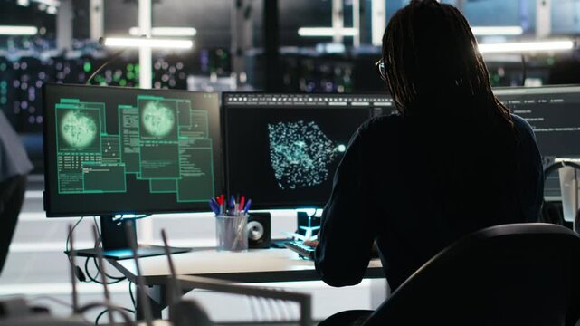 Cybersecurity team in data center responds to security breach, trying to prevent unauthorized access. Workers rushing to secure servers and protect sensitive information during cyberattack, camera B