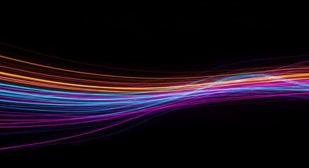 Abstract glowing light trails in vibrant colors against a dark black background creating a dynamic effect