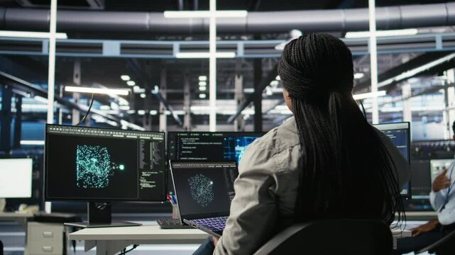 Server room IT expert using laptop to apply artificial intelligence technology minimizing system downtime. Technician using notebook to develop and deploy AI solutions optimizing equipment, camera A