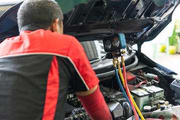 Car refilling air condition at car garage