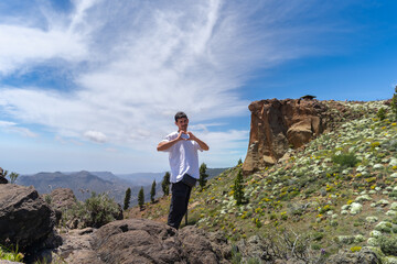 Young man hiking at the top of Gran Canaria Island in a sunny day. Canary islands. Spain