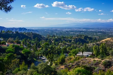 Obraz premium Panoramic View Of Green Hills And Urban Cityscape Under Bright Blue Sky