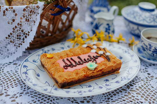 Easter table with mazurek cake on a porcelain plate