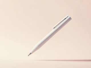 White pen hovering above a smooth surface in bright light