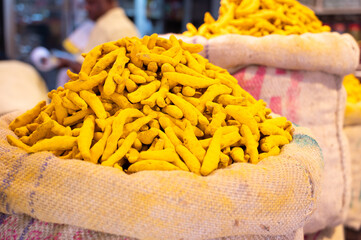 Turmeric root spices for sale on a spice market in India, fresh curcuma ingredients for cooking...