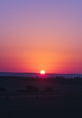 Vibrant Sunset Over a Purple and Orange Desert Landscape