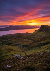 Obraz premium Vibrant Sunset Over Coastal Hills and Ocean