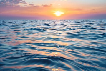 Sunset Over Ocean with Orange Sky and Blue Water Reflecting Sunlight