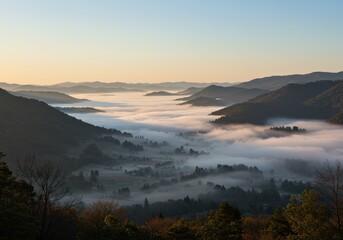 Obraz premium Early morning captures the mountain valley filled with a blanket of fog under a bright sky.