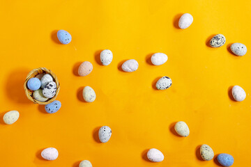 Easter celebration concept featuring painted decorative eggs on a bright orange background 