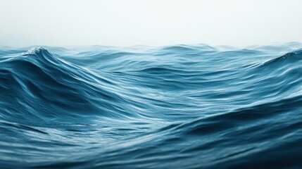 Vast, textured ocean waves in a tranquil, misty scene.