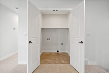 White room with a white door and a white closet