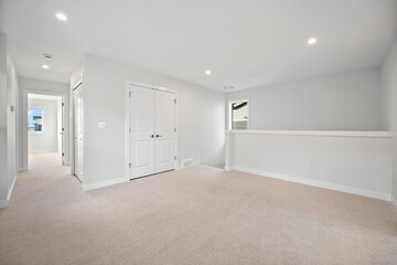 Large, empty room with a white door and a window