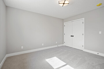 White room with a white door and a white wall