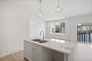 Kitchen with a white countertop and two sinks