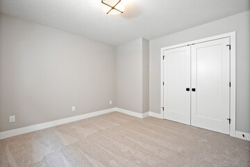 White room with a white door and a white wall