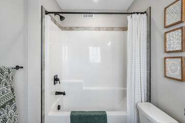 White bathroom with a bathtub and shower