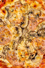 Homemade pizza with ham and mushrooms. A close shot of a pizza. Macro photo.Italian pizza capricciosa. Close-up
