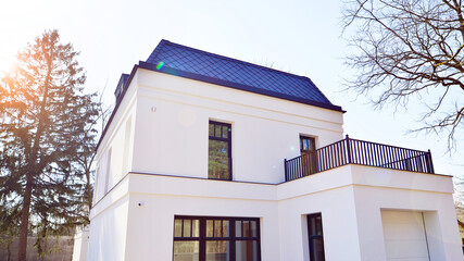 Luxury real estate single family house with white modern facade. A suburban district of single-family homes.